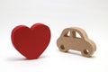 Red heart and a car on white background. Safe driving concept. Royalty Free Stock Photo