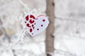 Red heart toy on tree with snow and icicle Royalty Free Stock Photo