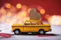 Red heart on toy yellow  taxi car on red background. Travel love concept with copy space Royalty Free Stock Photo