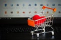 Red heart in a trolley on a laptop keyboard. Ideas about online shopping, online shopping