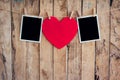 Red heart and two photo frame hanging on clothesline rope with w Royalty Free Stock Photo