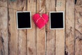 Red heart and two photo frame hanging on clothesline rope with w Royalty Free Stock Photo