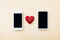 Red heart in between two smartphone, Love line and connection Royalty Free Stock Photo