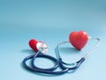 Red heart using deep blue stethoscope on the blue background for hear their other heart. Concept of love and caring patient by the Royalty Free Stock Photo