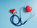 Red heart using deep blue stethoscope on the blue background for hear their other heart. Concept of love and caring patient by the Royalty Free Stock Photo