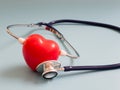 Red heart using deep blue stethoscope on the blue background for hear their own heart. Concept of love and caring patient by the h Royalty Free Stock Photo