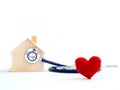 Red heart using stethoscope on the blue background for house health check. Concept of love and caring patient house by the heart. Royalty Free Stock Photo