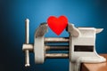 Red heart in the vice tool Royalty Free Stock Photo