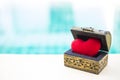 Red heart in vintage wooden treasure box over blurred blue water background Royalty Free Stock Photo