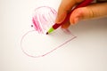 Child drawing heart on white background baby fingers