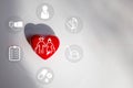 A red heart on a white paper and an elderly icon in a heart shape, a concept showing caring for elderly people Royalty Free Stock Photo