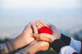 Red heart in woman and man hands, hands holding a soft heart shape, Couple love, Valentine`s Day