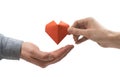 Red heart in woman and man hands. Image on isolated white background. Royalty Free Stock Photo