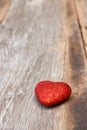 Red heart on wood background.