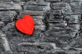 Red heart wood lies on black burnt Board, Royalty Free Stock Photo