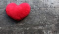 Red heart on wooden background