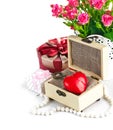 Red heart wooden casket with bunch roses
