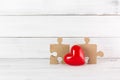 Red Heart with Wooden Puzzle Jigsaw on white wood background. Relations of Love concept with Copy Space Royalty Free Stock Photo