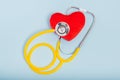 Red heart, Yellow Stethoscope on blue background with Copy space. Medical concept, Health care concept Royalty Free Stock Photo