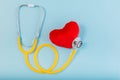 Red heart, Yellow Stethoscope on blue background with Copy space. Medical concept, Health care concept Royalty Free Stock Photo