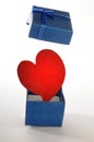 Red Hearth opening a blue gift box Royalty Free Stock Photo