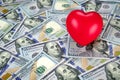 Red hearth on top of new one hundred dollar bills Royalty Free Stock Photo