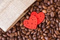 Red hearts against the background of coffee beans. Love for coffee_ Royalty Free Stock Photo