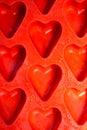 Red hearts background, silicone ice molds in the form of hearts Royalty Free Stock Photo