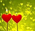 Red hearts candles on yellow hearts bokeh as background Royalty Free Stock Photo