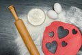 Red hearts cut out dough with rolling pin, eggs and flour on a b Royalty Free Stock Photo