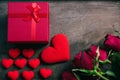 Red hearts, flower roses and gift box on wooden background Royalty Free Stock Photo