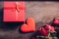 Red hearts, flower roses and gift box on wooden background Royalty Free Stock Photo