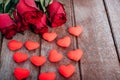 Red hearts, flower roses and gift box on wooden background Royalty Free Stock Photo