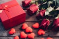 Red hearts, flower roses and gift box on wooden background Royalty Free Stock Photo