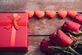 Red hearts, flower roses and gift box on wooden background Royalty Free Stock Photo