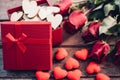 Red hearts, flower roses and gift box on wooden background Royalty Free Stock Photo