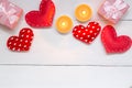 Red hearts and gift on white wooden background for Valentines day, copy space, top view