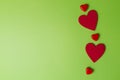 Red hearts greenery valentines day background. Minimal style. Flat lay. Top view. Copy space Royalty Free Stock Photo