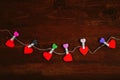 Red hearts hanging on rope on wood