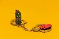 Red hearts and a house in handcuffs on a yellow background. Royalty Free Stock Photo