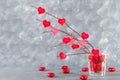 Red hearts with an inscription Love hang on branches on a gray concrete background. Love tree. The concept of Valentine's Day. A Royalty Free Stock Photo