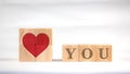 Red hearts and letters are displayed on square wooden blocks. Indicate love. Royalty Free Stock Photo