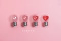 Red hearts in light bulbs. Loading progress bar on pink background