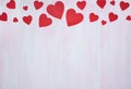 Red hearts on a lilac wooden background