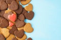 Red hearts made of glazed gingerbreads over a bunch of cookies