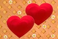 Red hearts made of shiny colored paper on a decorative grid with white daisies