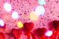 Red hearts on pink background with bokeh and confetti with space for text. Valentine's day, birthday. Royalty Free Stock Photo