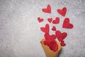 Red hearts pouring in waffle horn. Valentines love, date concept with copy space, flat lay