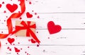 Red hearts, ribbon and gift on white wooden background. Top view, free space for text. valentine`s day, love Royalty Free Stock Photo