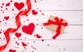 Red hearts, ribbon and gift on white wooden background. Top view, free space for text. valentine`s day, love Royalty Free Stock Photo